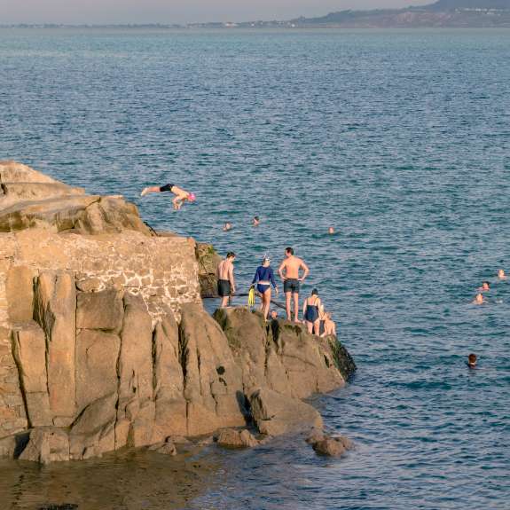 Beachgoers jumping off the forty foot